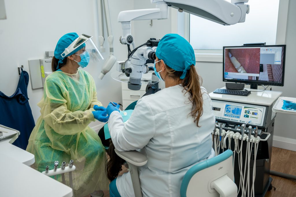 An endodontist is doing the root canal procedure